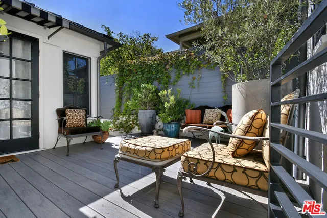 a backyard of a house with barbeque oven table and chairs
