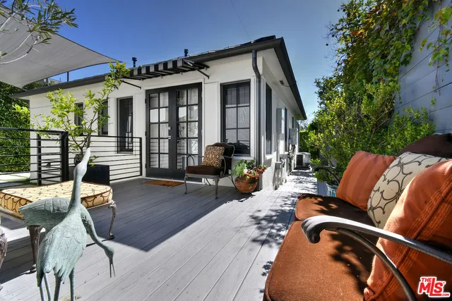 a view of a patio with couches chairs and potted plants