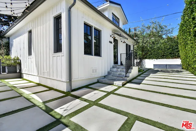 a view of a house with backyard and sitting area