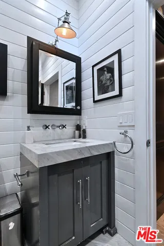 a bathroom with a sink vanity and a mirror