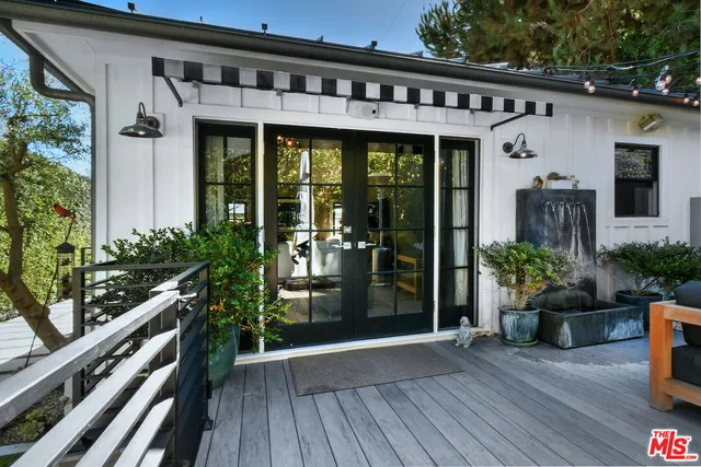 a front view of house with deck and outdoor seating