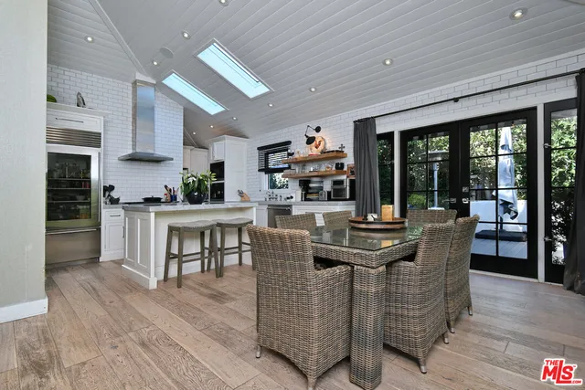 a dining room with furniture and wooden floor