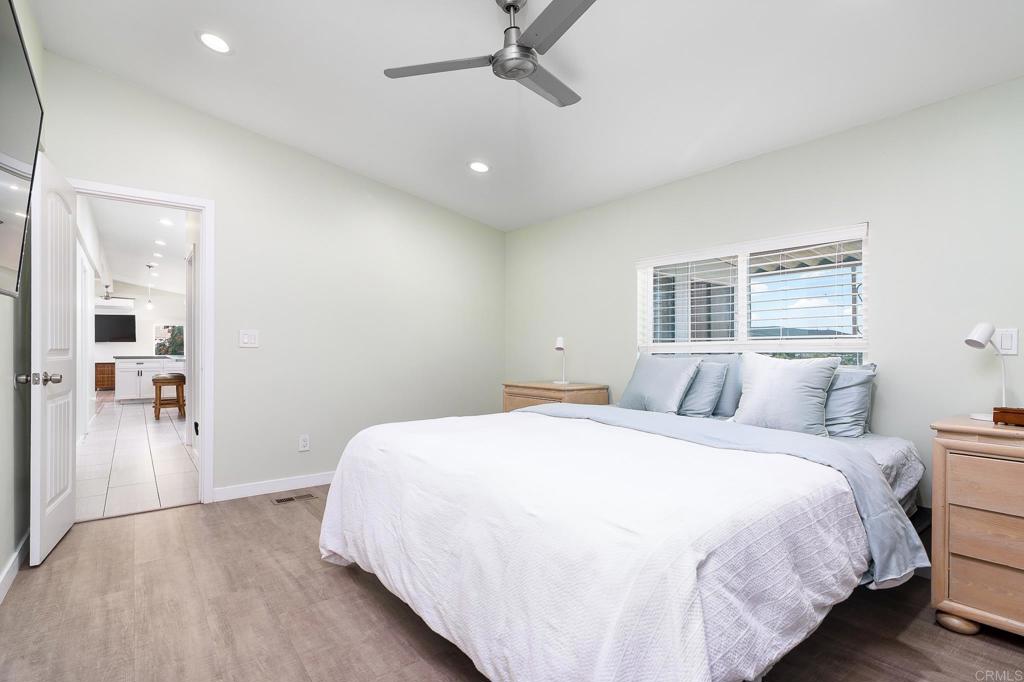500 Rancheros Drive, Unit 73 San Marcos, CA 92069 - Photo 15 of 52 a bedroom with a large bed and a chandelier