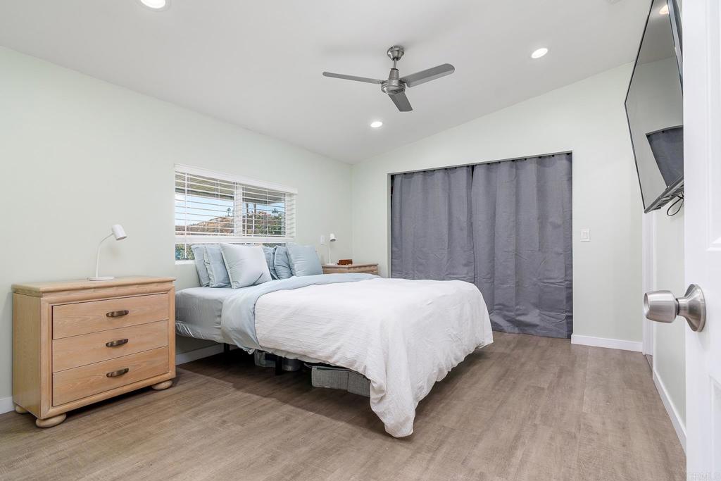500 Rancheros Drive, Unit 73 San Marcos, CA 92069 - Photo 16 of 52 a bedroom with a bed and a mirror
