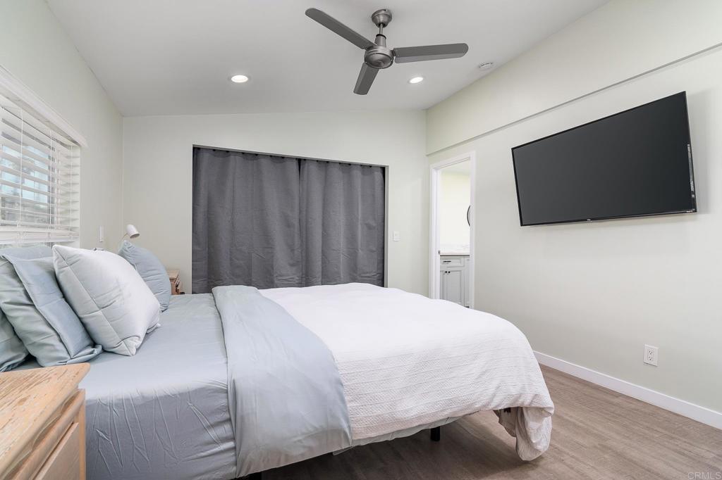 500 Rancheros Drive, Unit 73 San Marcos, CA 92069 - Photo 17 of 52 a bedroom with a large bed and a flat screen tv