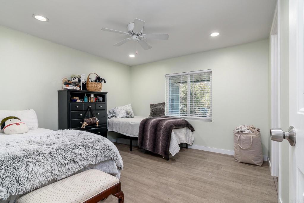500 Rancheros Drive, Unit 73 San Marcos, CA 92069 - Photo 22 of 52 a bedroom with two beds and a chandelier