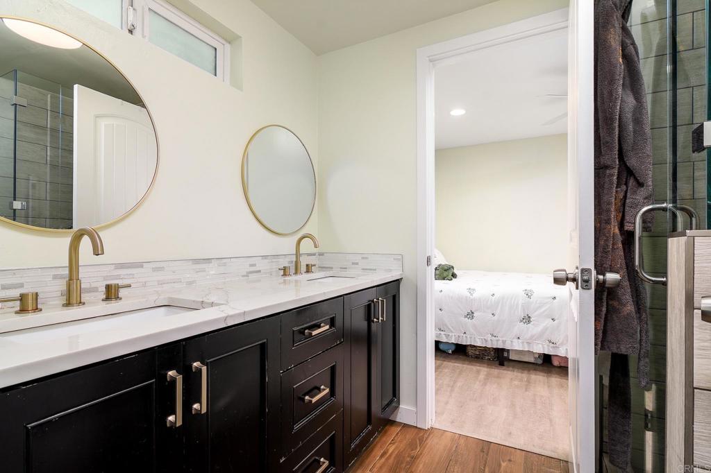 500 Rancheros Drive, Unit 73 San Marcos, CA 92069 - Photo 23 of 52 a en suite bathroom with a double vanity sink and a mirror