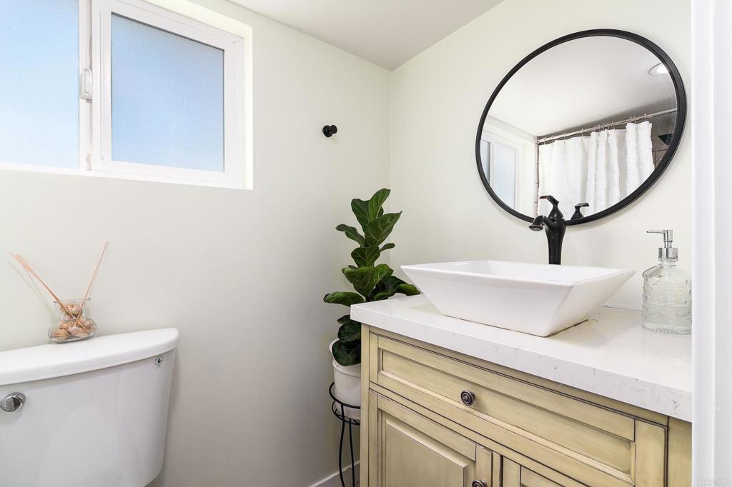 500 Rancheros Drive, Unit 73 San Marcos, CA 92069 - Photo 28 of 52 a bathroom with a sink a mirror and a toilet