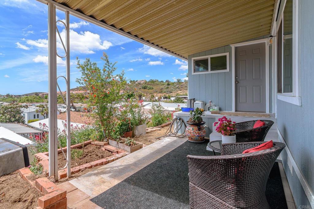 500 Rancheros Drive, Unit 73 San Marcos, CA 92069 - Photo 33 of 52 a living room filled with furniture and a floor to ceiling window