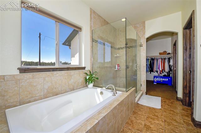 12645 Herring Road Colorado Springs, CO 80908 - Photo 4 of 12 Bathroom with tile patterned floors and plus walk in shower