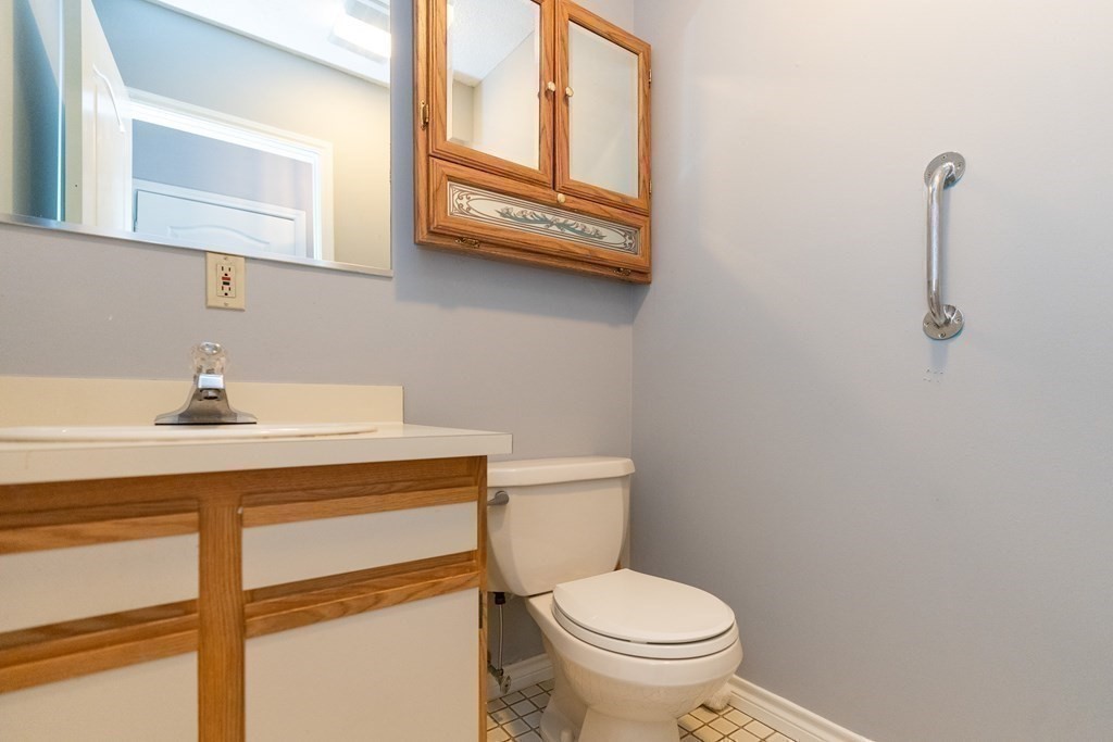 104 Johnson Road, Unit 106 Chicopee, MA 01022 - Photo 17 of 24 a bathroom with a sink a toilet and mirror