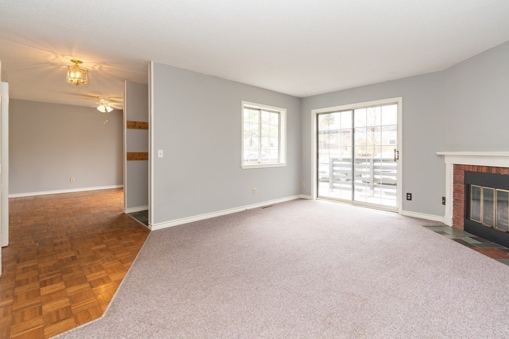 104 Johnson Road, Unit 106 Chicopee, MA 01022 - Photo 5 of 24 an empty room with windows and fireplace