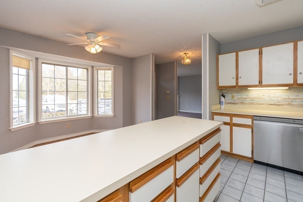 104 Johnson Road, Unit 106 Chicopee, MA 01022 - Photo 7 of 24 a kitchen with a stove a sink and a window