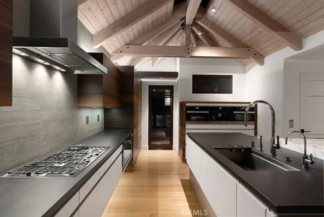 a kitchen with stainless steel appliances granite countertop a sink a stove and a refrigerator