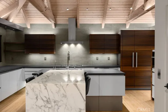 a living room with stainless steel appliances kitchen island granite countertop a stove a sink and a microwave