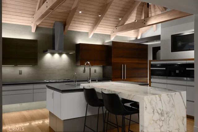 a kitchen with stainless steel appliances kitchen island granite countertop a sink and cabinets