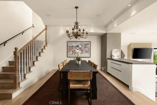 a view of a hallway with furniture and a chandelier