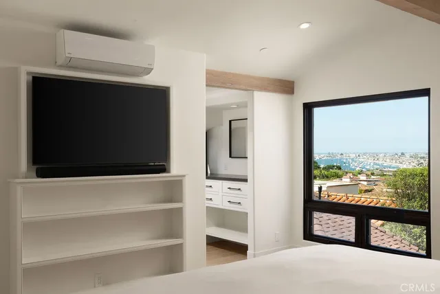 a view of a living room with a flat screen tv and a floor to ceiling window