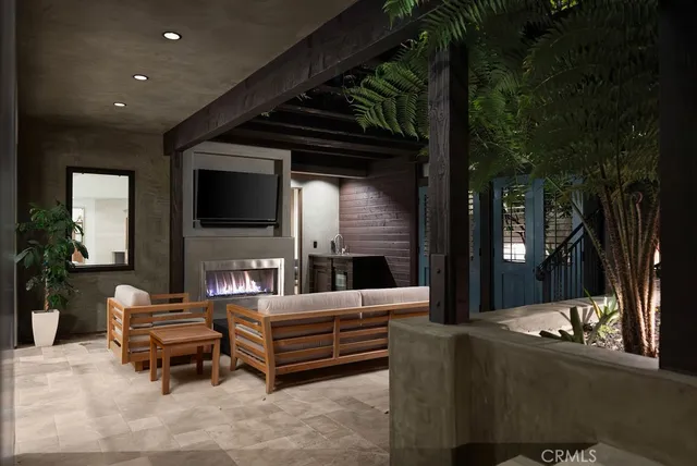 a bedroom with a large bed and a flat tv screen