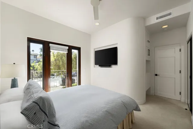a living room with a bed furniture and a flat screen tv
