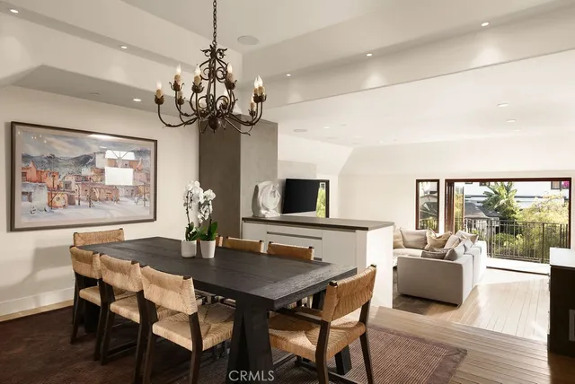 a view of a dining room with furniture wooden floor and chandelier