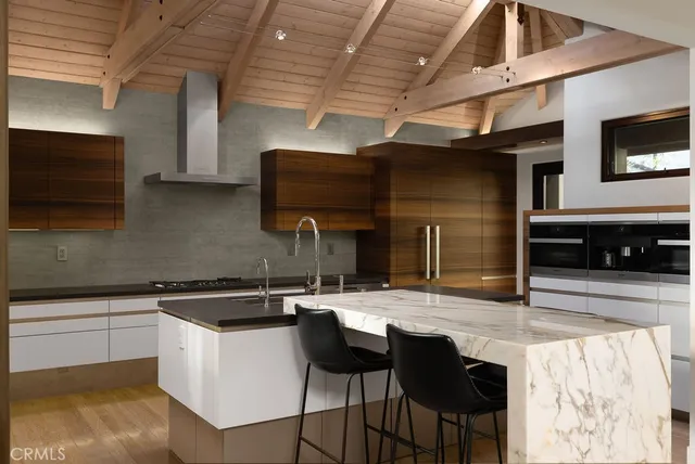 a kitchen with stainless steel appliances kitchen island granite countertop a sink and cabinets