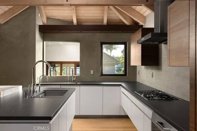 a kitchen with kitchen island a sink stove top oven and microwave