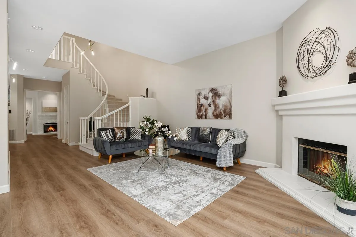 9605 Claiborne Square La Jolla, CA 92037 - Photo 12 of 34 a living room with furniture and a fireplace