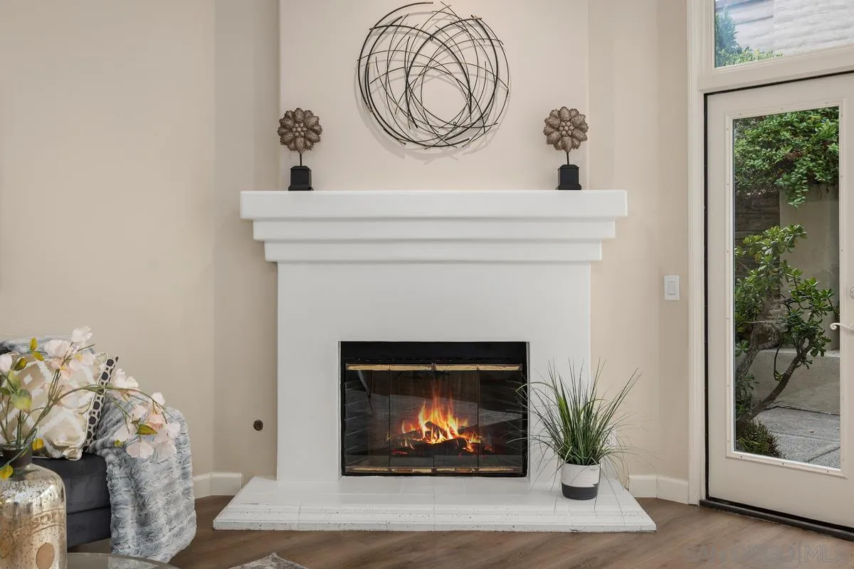 9605 Claiborne Square La Jolla, CA 92037 - Photo 13 of 34 a living room with a fireplace and a potted plant