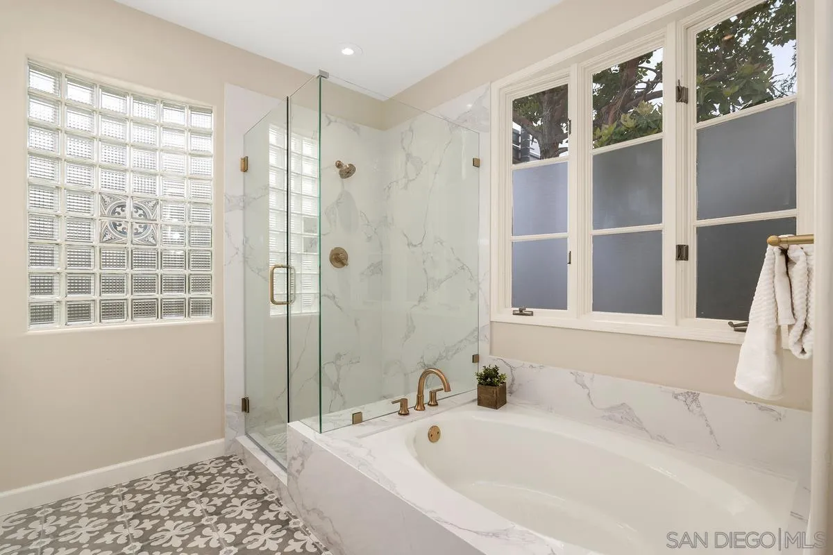 9605 Claiborne Square La Jolla, CA 92037 - Photo 23 of 34 a bathroom with a bathtub and a shower