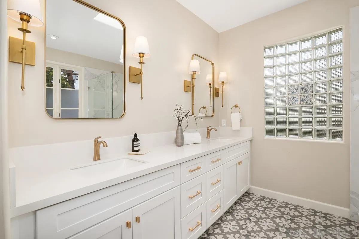 9605 Claiborne Square La Jolla, CA 92037 - Photo 24 of 34 a bathroom with a double vanity sink mirror and