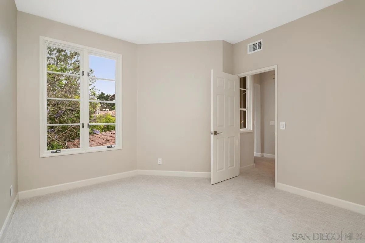 9605 Claiborne Square La Jolla, CA 92037 - Photo 26 of 34 an empty room with windows and closet
