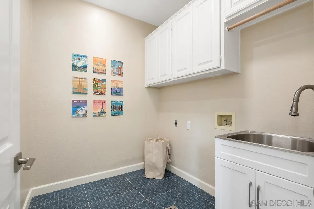 9605 Claiborne Square La Jolla, CA 92037 - Photo 27 of 34 a view of storage and utility room with a sink