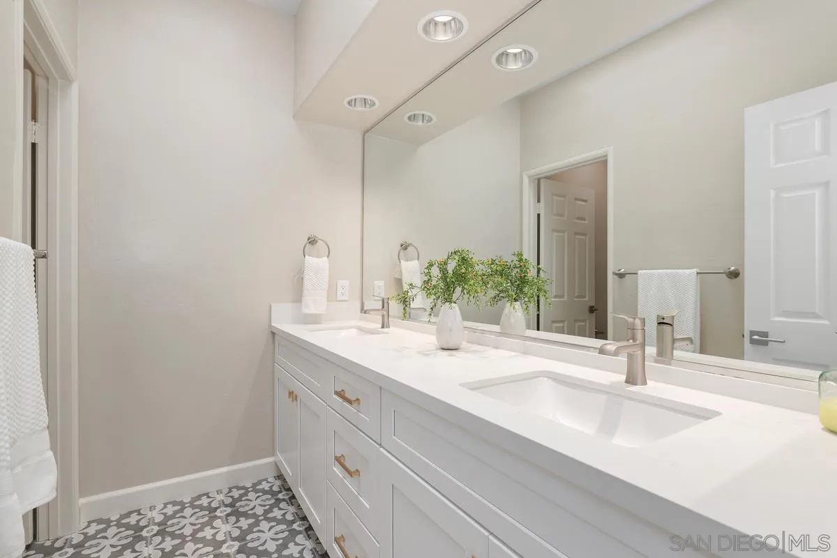 9605 Claiborne Square La Jolla, CA 92037 - Photo 28 of 34 a bathroom with a sink and a mirror