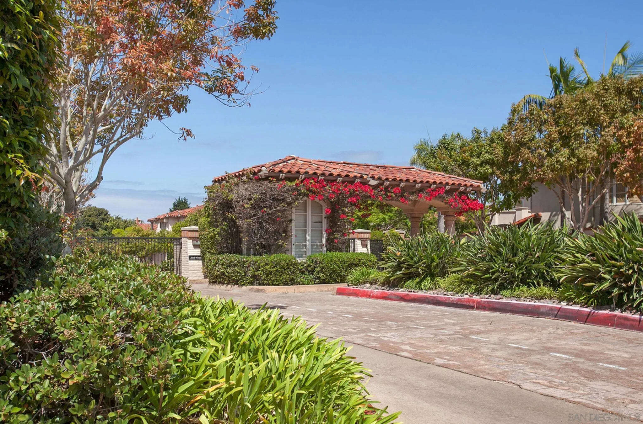 9605 Claiborne Square La Jolla, CA 92037 - Photo 33 of 34 a front view of a house with a yard and garage