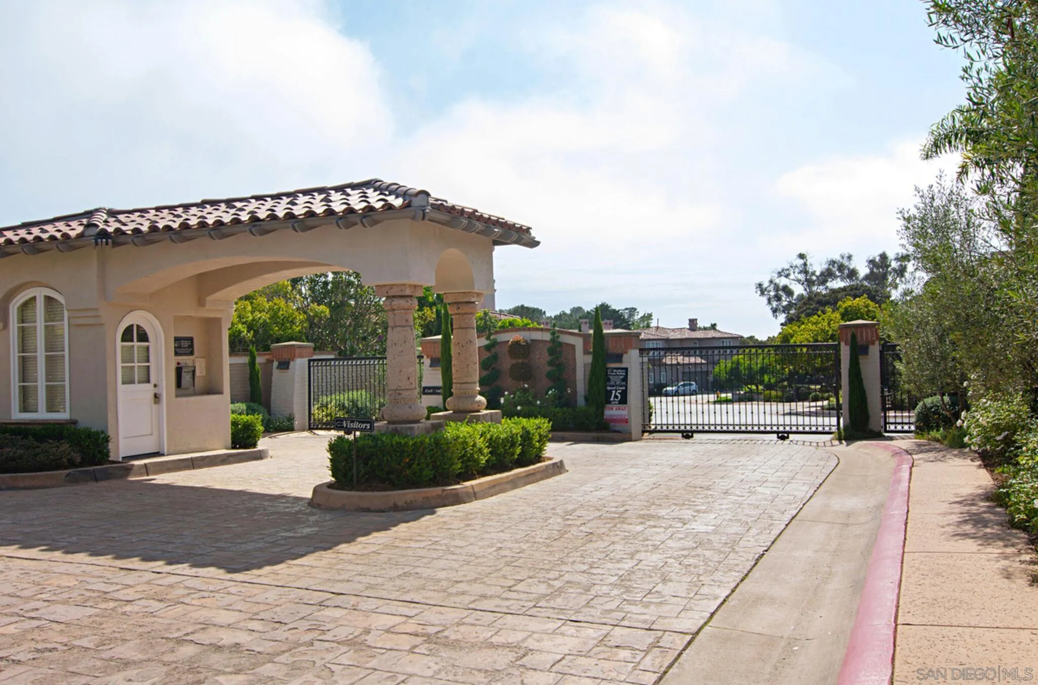 9605 Claiborne Square La Jolla, CA 92037 - Photo 34 of 34 a front view of a house with a garden