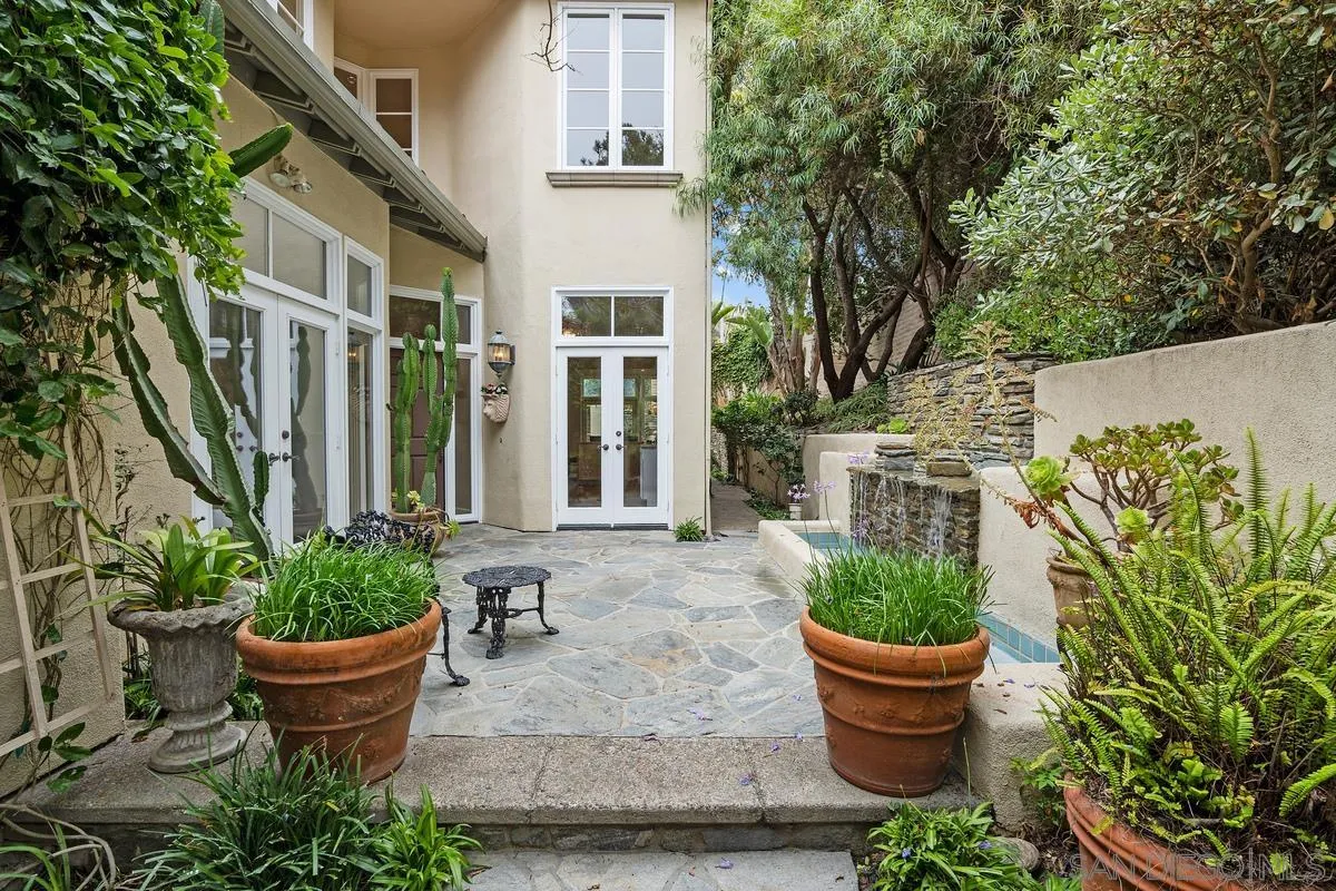 9605 Claiborne Square La Jolla, CA 92037 - Photo 4 of 34 a front view of a house with potted plants