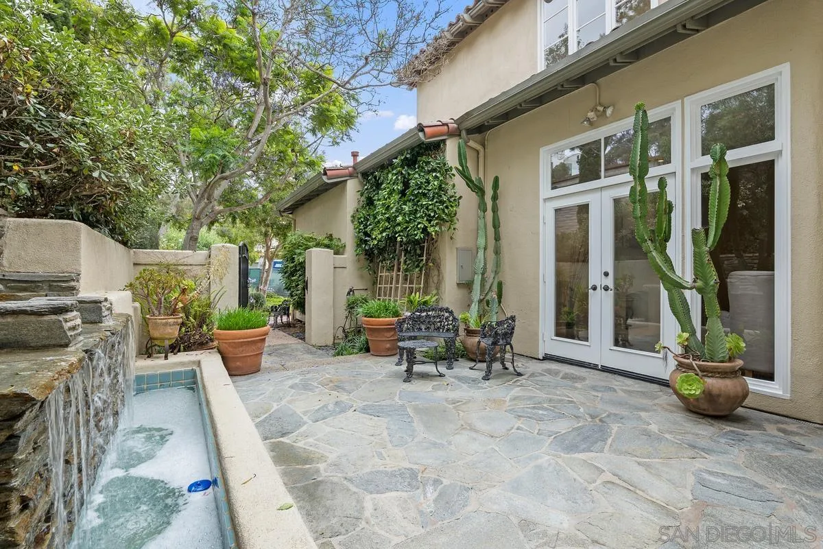 9605 Claiborne Square La Jolla, CA 92037 - Photo 5 of 34 a view of a patio with table and chairs and potted plants