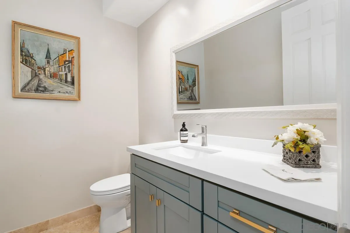 9605 Claiborne Square La Jolla, CA 92037 - Photo 10 of 34 a bathroom with a sink a toilet and a mirror