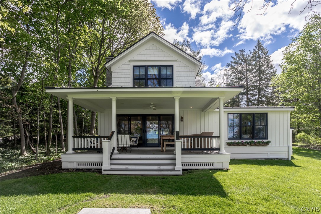2433 East Lake Road Spafford, NY 13152 - Photo 1 of 1 Lake side of house with covered porch