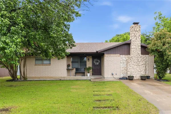 a front view of house with yard and outdoor seating