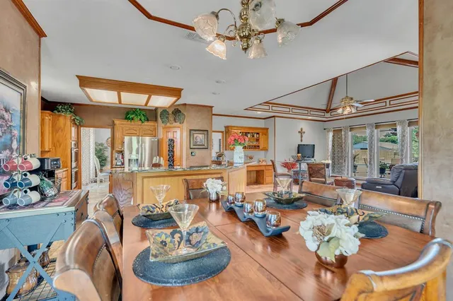 a view of a dining room with furniture and chandelier