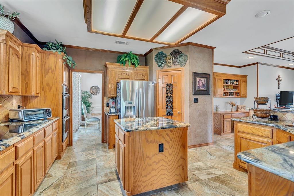 50 Buckingham Lane Allen, TX 75002 - Photo 21 of 39 a kitchen with stainless steel appliances granite countertop a sink stove and refrigerator