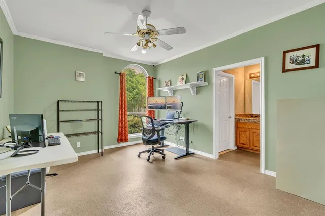 a bedroom with a bed gym equipment and a large window