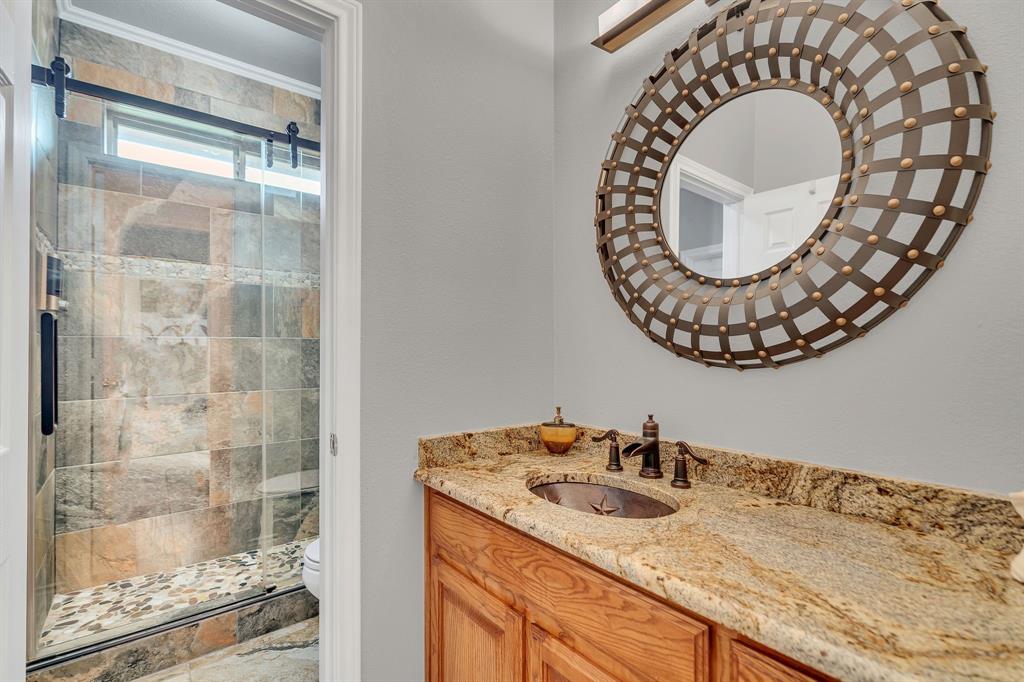 50 Buckingham Lane Allen, TX 75002 - Photo 31 of 39 a bathroom with a granite countertop sink mirror and vanity