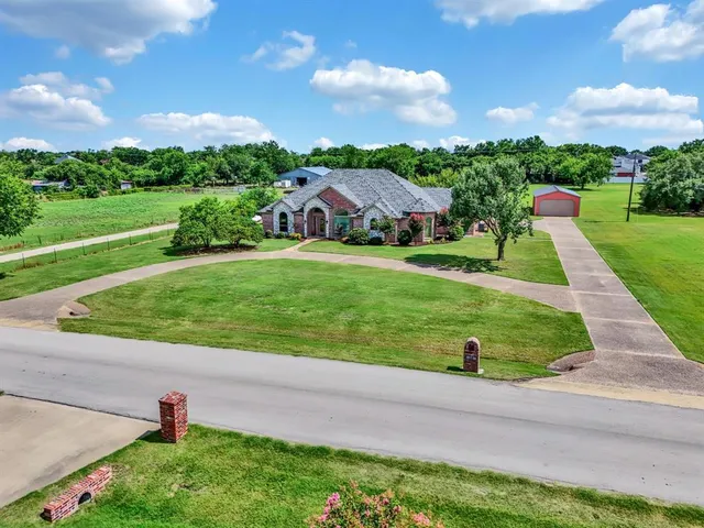 a view of a garden with a house
