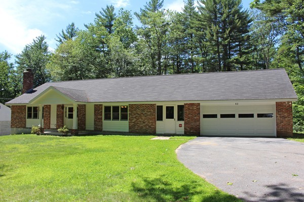 62 Adams Road Townsend, MA 01469 - Photo 1 of 16 a front view of a house with a yard and trees