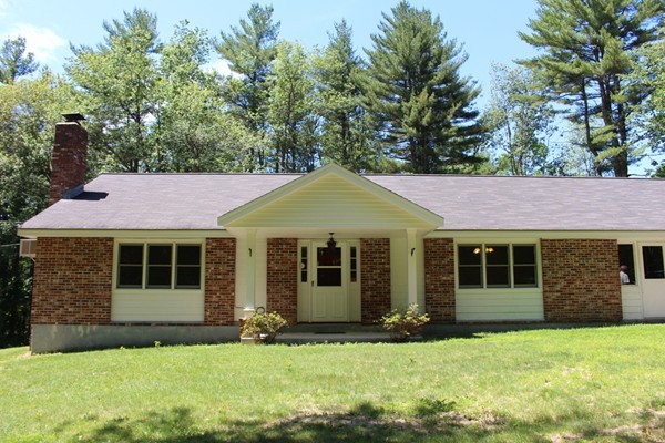 62 Adams Road Townsend, MA 01469 - Photo 14 of 16 a front view of a house with a yard and garage