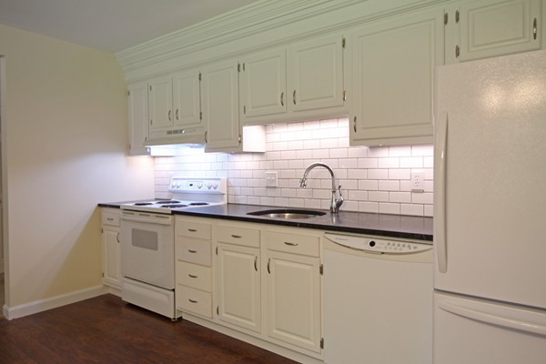 62 Adams Road Townsend, MA 01469 - Photo 2 of 16 a kitchen with granite countertop white cabinets and white appliances