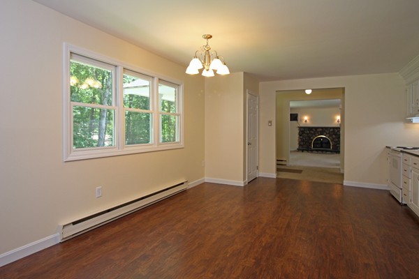 62 Adams Road Townsend, MA 01469 - Photo 3 of 16 a view of an empty room with wooden floor and a window